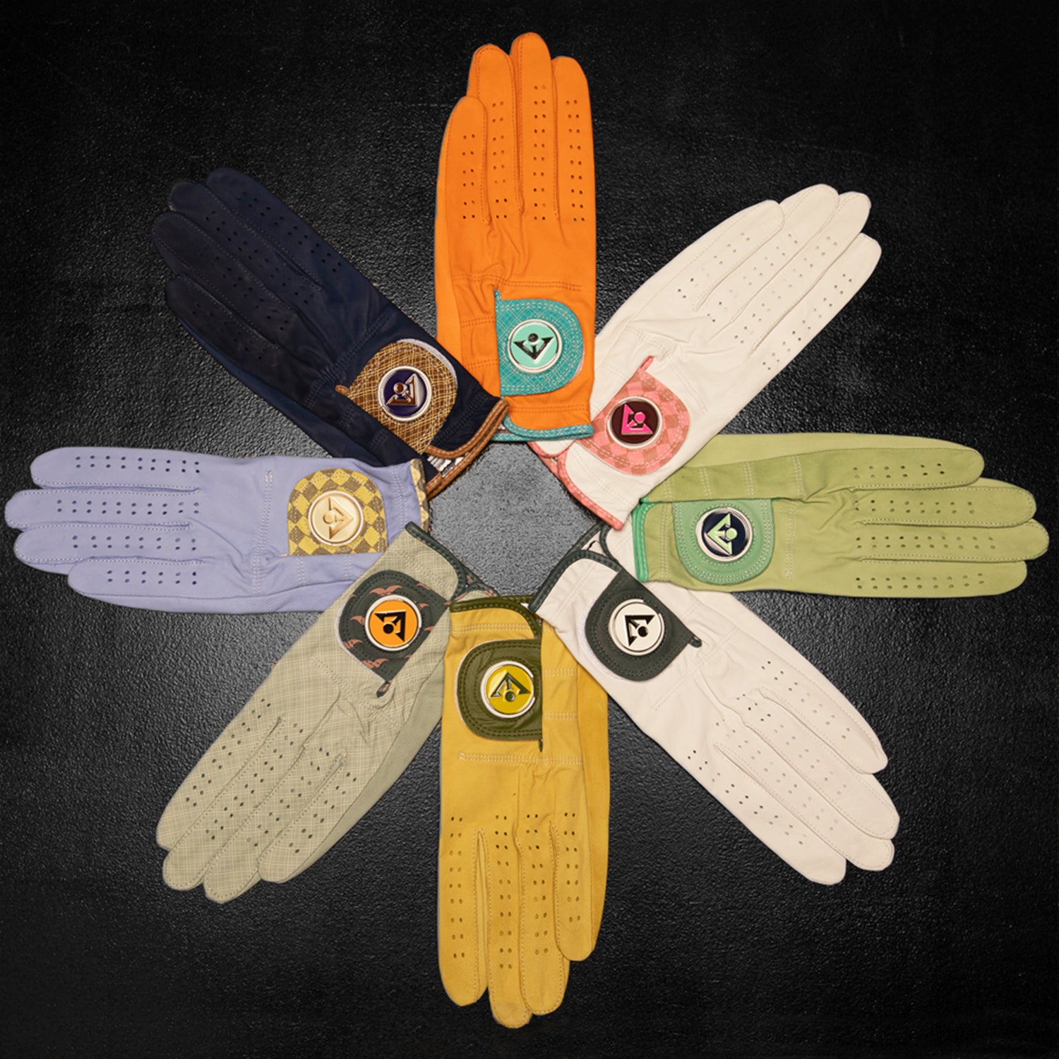 Various golf gloves with ball markers laid out in a circle, consisting of unique colors and patterns by VivanTee Golf.