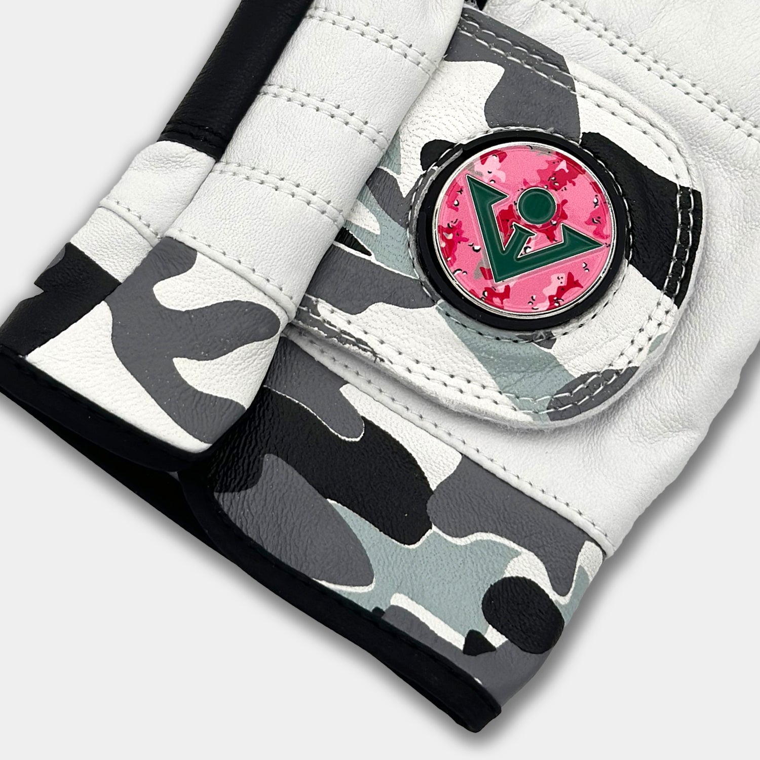 Close up of VivanTee women's gowanus ghost ghost golf glove with a pink camo golf ball marker. 