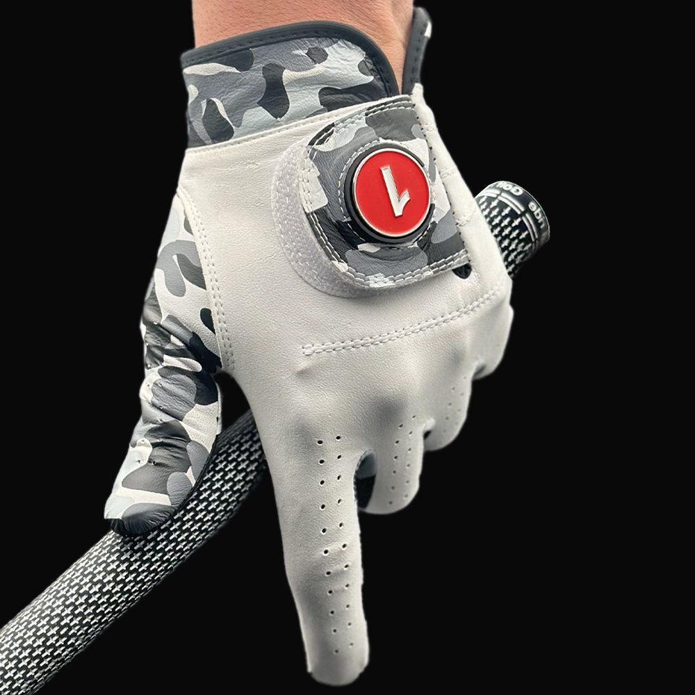 Golf glove with camo and red ball marker holding a golf club with black backdrop.