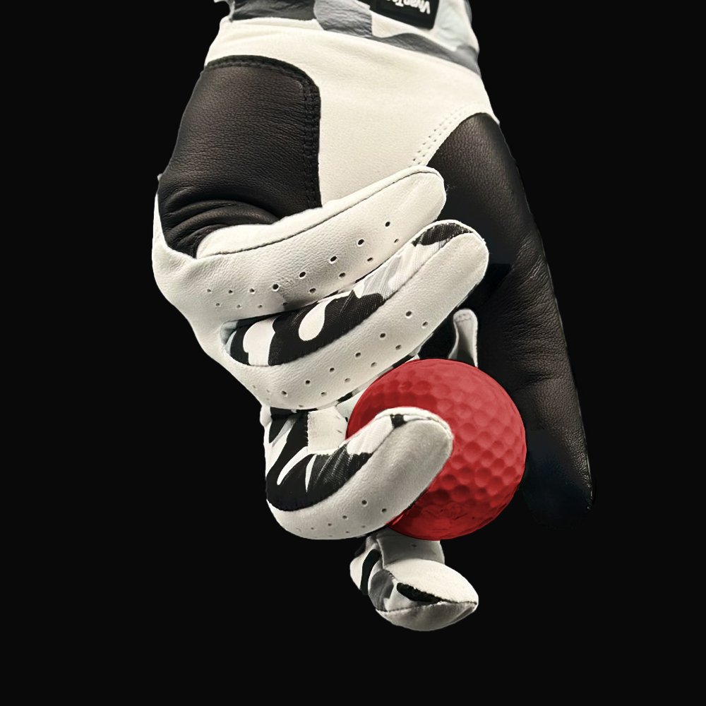 Close up of camo golf glove with lycra holding a red golf ball, zooming in to showcase the camo print lycra.