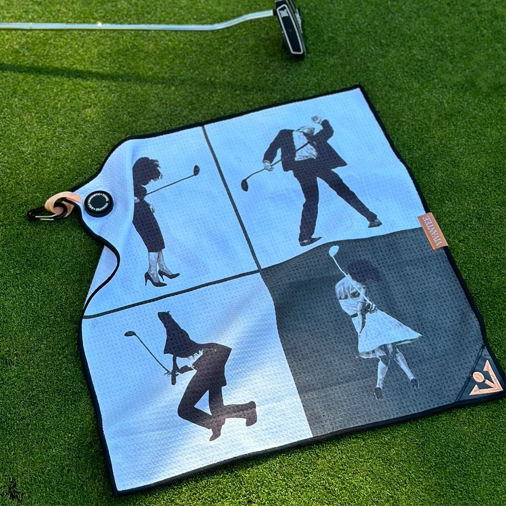 Metro moves black and white magnetic golf towel by VivanTee on the green next to a putter.