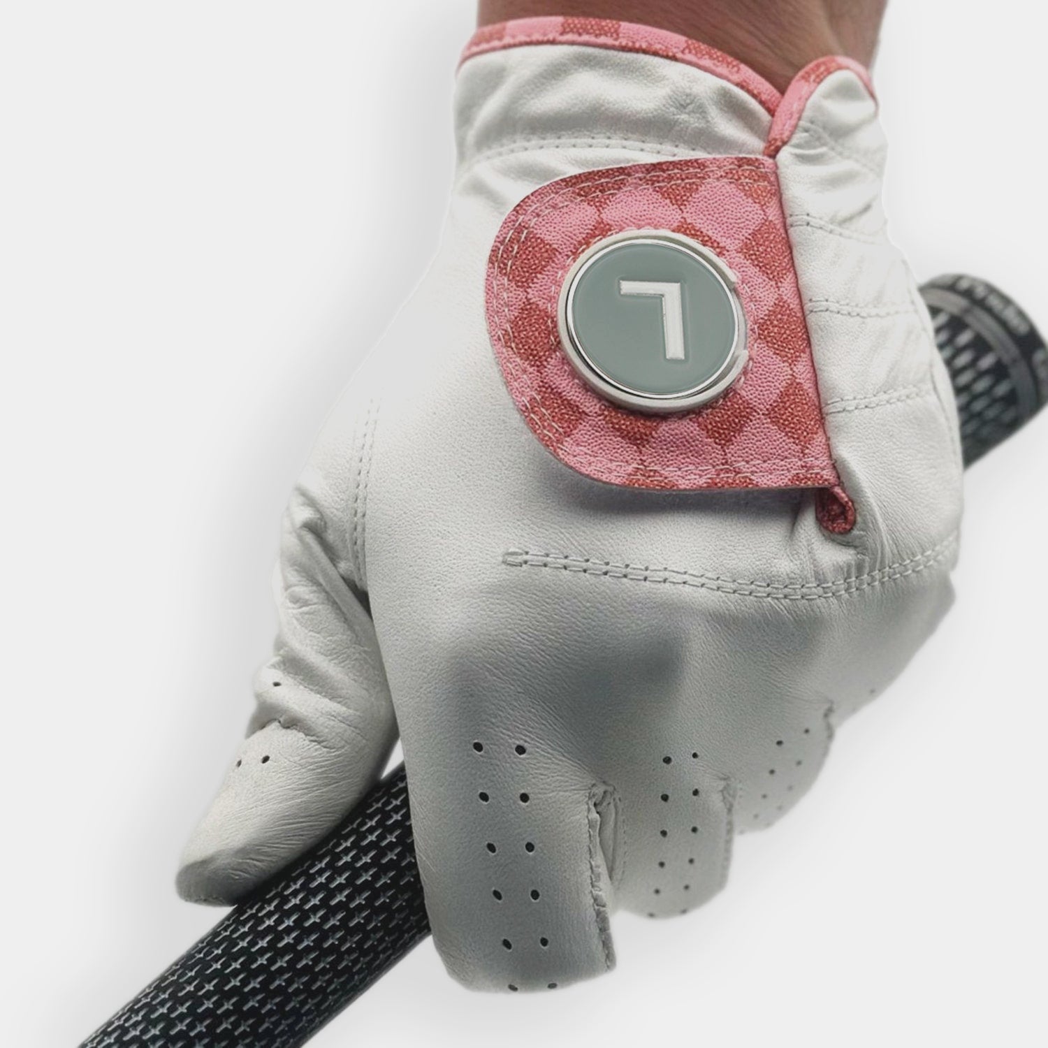 VivanTee men's golf glove in pink checkered print, featuring a silver "L" marker holding a golf club, close up.