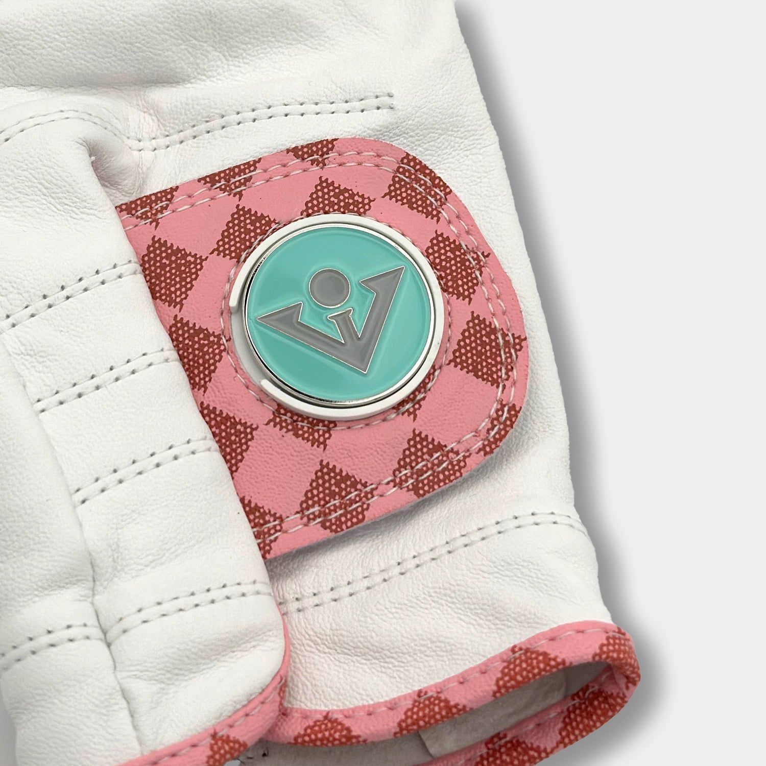 Close up of women's pink checkered golf glove with tiffany blue ball marker by VivanTee Golf.