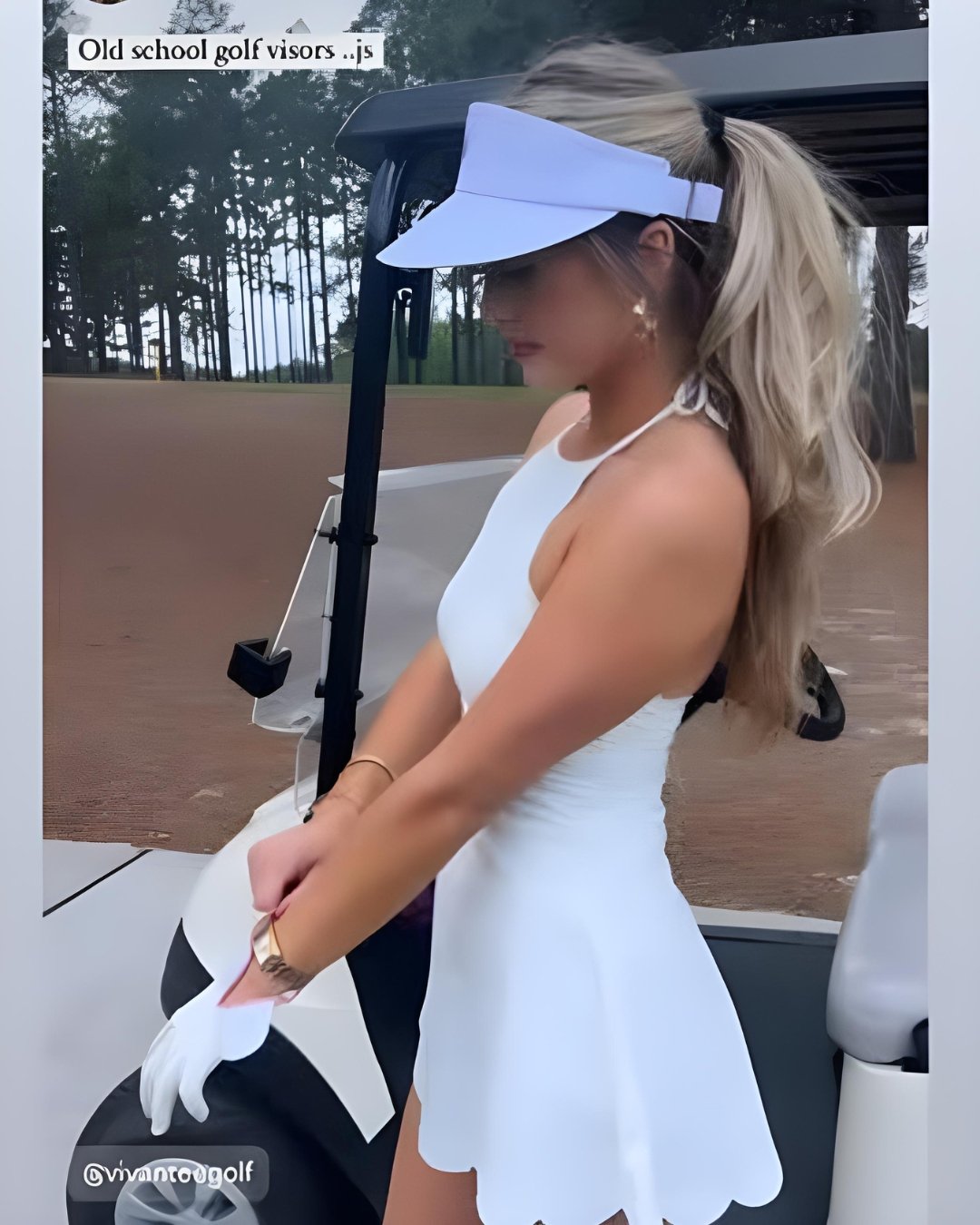 Stylish golfer in a white dress and white visor putting on a fancy golf glove by VivanTee Golf.