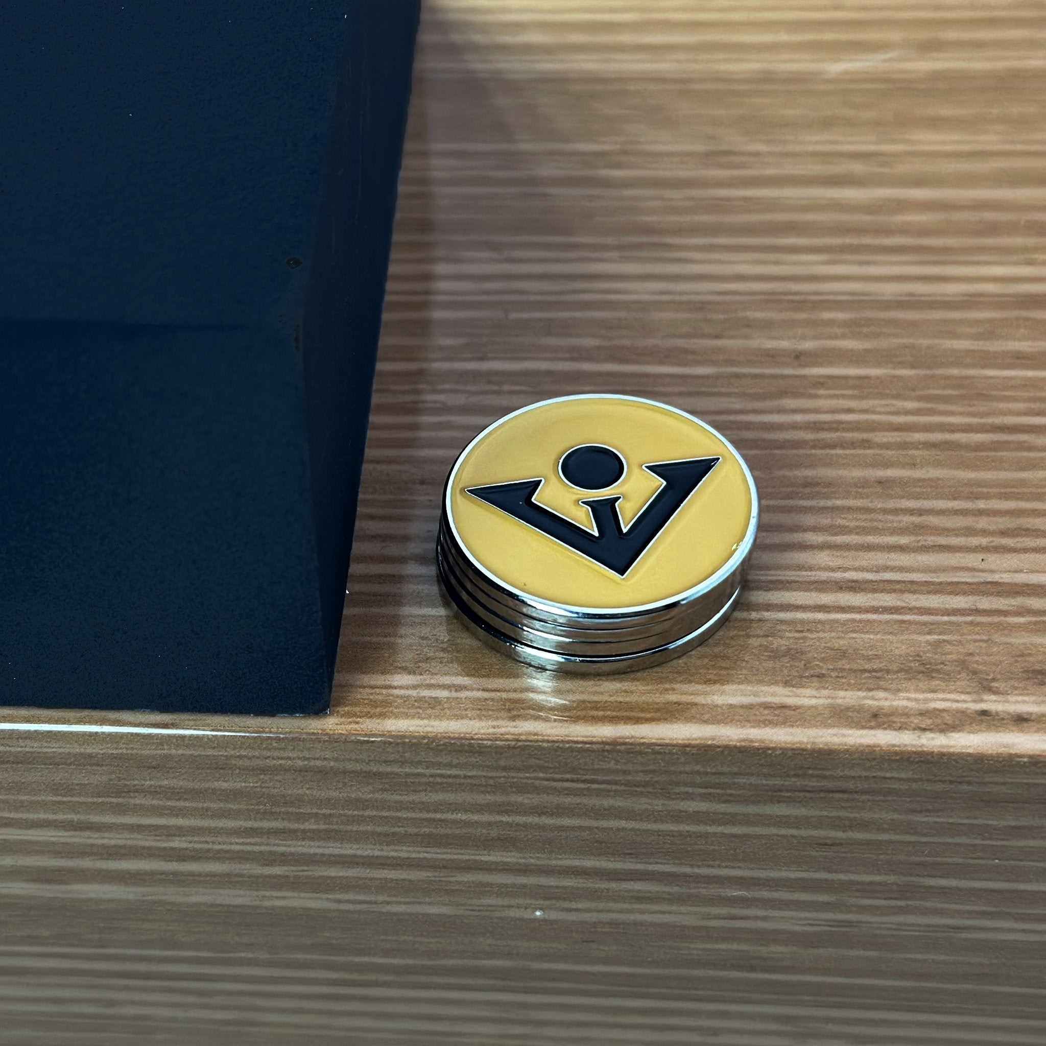 Black and Tan Golf Ball Marker with black background and tan belt.